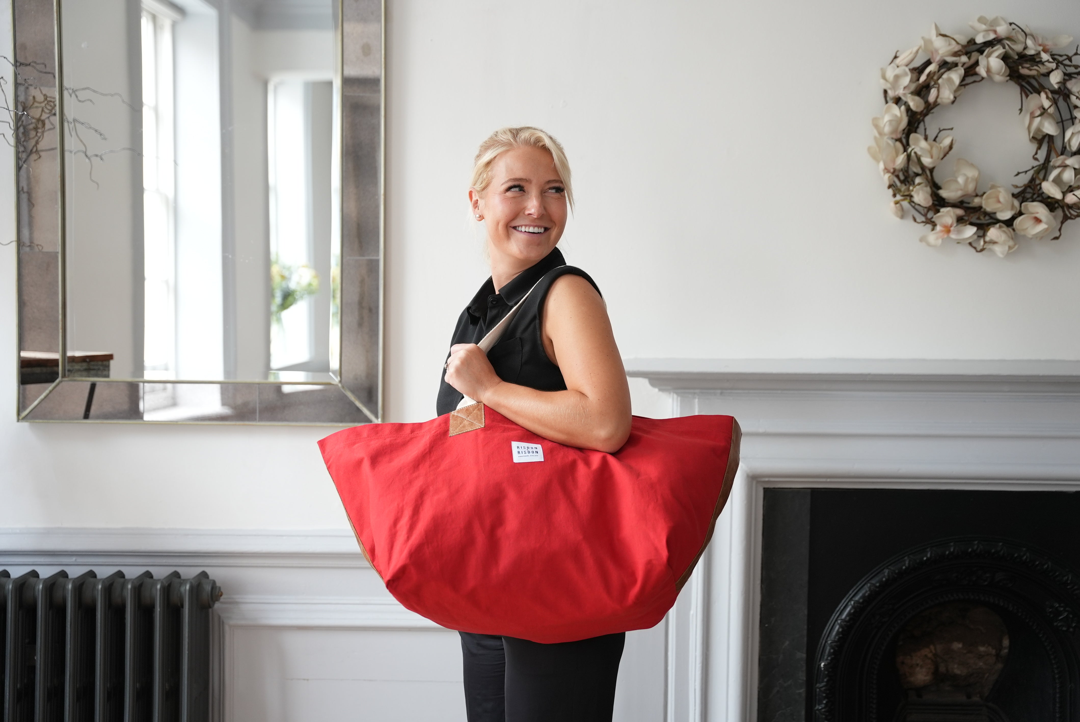 A lady carrying risdon and risdon canvas and leather market bag made in england.